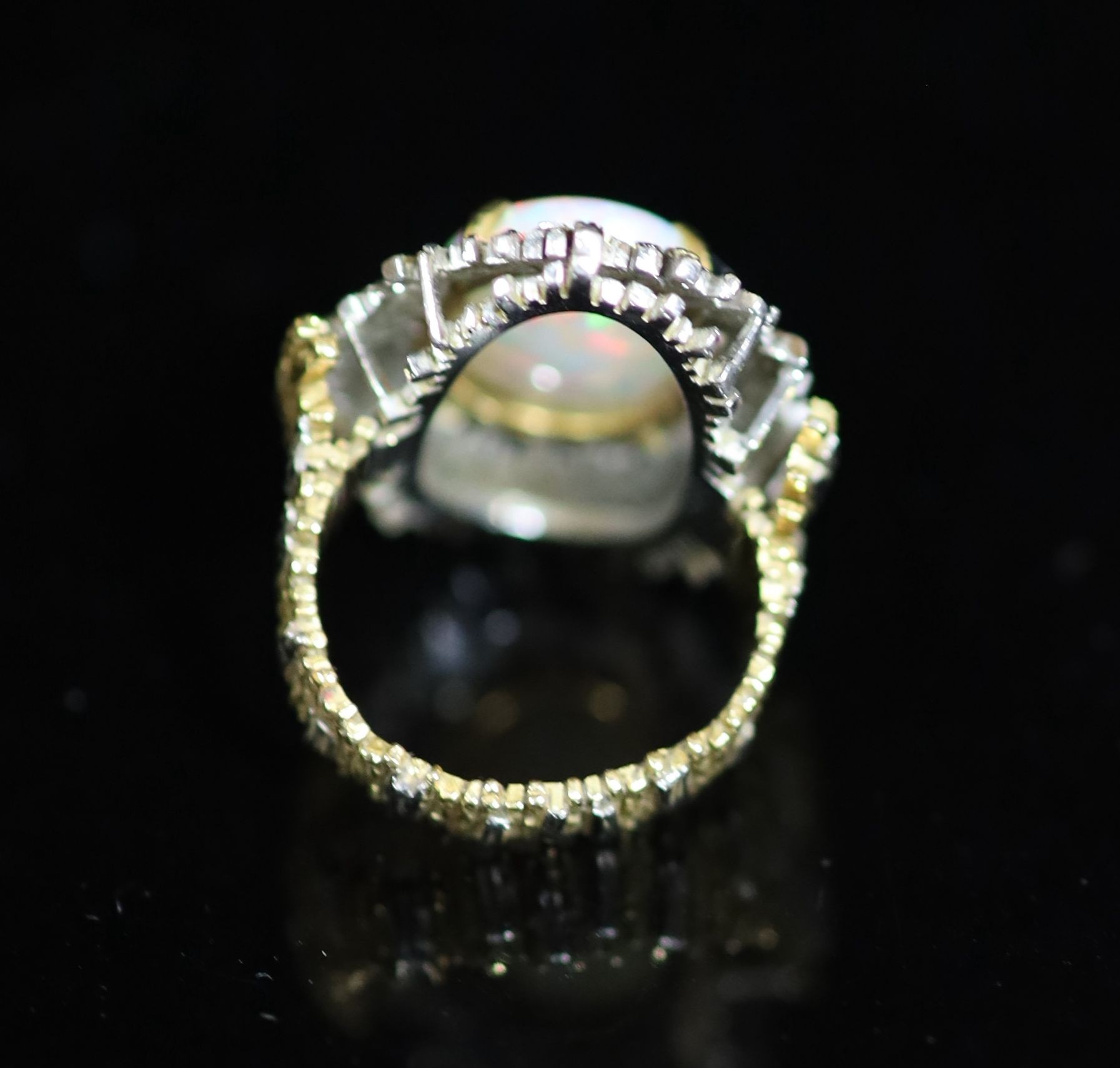 A 1970's? textured two colour 18ct gold and white opal set oval dress ring